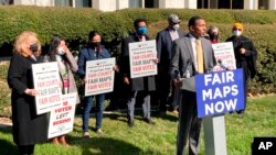 FILE - Reggie Weaver, at podium, speaks outside the Legislative Building in Raleigh, N.C, on Feb. 15, 2022, about a recent partisan gerrymandering ruling by the North Carolina Supreme Court.