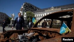 Britain's Foreign Secretary David Cameron walks past a display of destroyed Russian military vehicles in Saint Michael's Square, amid Russia's attack on Ukraine, in Kyiv, Ukraine, May 2, 2024.