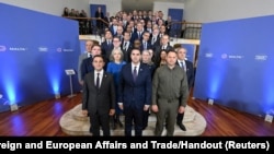 Delegates pose for a photo at the weekend meeting — organized by Ukraine to discuss its peace formula for ending the war with Russia — being held in an undisclosed location in St Julian's, Malta, Oct. 28, 2023. (Ministry for Foreign and European Affairs and Trade/Reuters)
