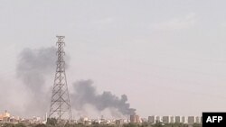 FILE - A picture taken from Omdurman shows smoke billowing north of Khartoum, Sudan, July 22, 2023, as fighting between the country's army and a rival military faction continues.