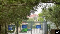 Buildings in the Shanghai Public Health Clinical Center stand near the entrance of the compound in Shanghai, April 30, 2024. Scientist Zhang Yongzhen staged a sit-in protest after authorities locked him out of his lab at the center.
