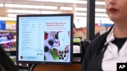 Jaqueline Benitez, who depends on California's SNAP benefits to help pay for food, pays for groceries in Bellflower, Calif., Feb. 13, 2023. Officials in 32 states have been letting recipients know that food stamp supplemental benefits are ending.