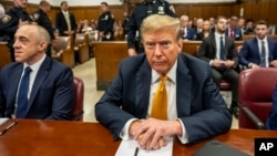 Former U.S. President Donald Trump sits in Manhattan Criminal Court in New York, May 21, 2024.