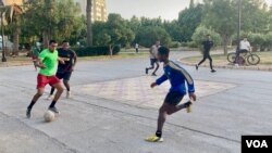 Young men play soccer in Tunis. While Tunisia has been a historic melting pot, rights groups say Black African migrants have recently faced a surge in racist attacks. (Lisa Bryant/VOA)