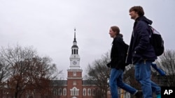 FILE - Students cross the campus of Dartmouth College in Hanover, New Hampshire, March 5, 2024. After months of delays and technical hiccups, some colleges and universities have started to receive federal data they need to put together financial aid offers for incoming students. 