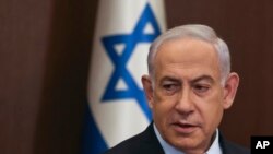 FILE - Israeli Prime Minister Benjamin Netanyahu attends the weekly Cabinet meeting in Jerusalem, Dec. 10, 2023. Netanyahu left for Washington on Monday, leaving behind a brutal war to make a politically precarious speech before the US Congress.