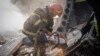 In this photo provided by the Ukrainian Emergency Service, Ukrainian emergency personnel work at the site of Russia's air attack in Khmelnytskyi, Ukraine, March 22, 2024. 