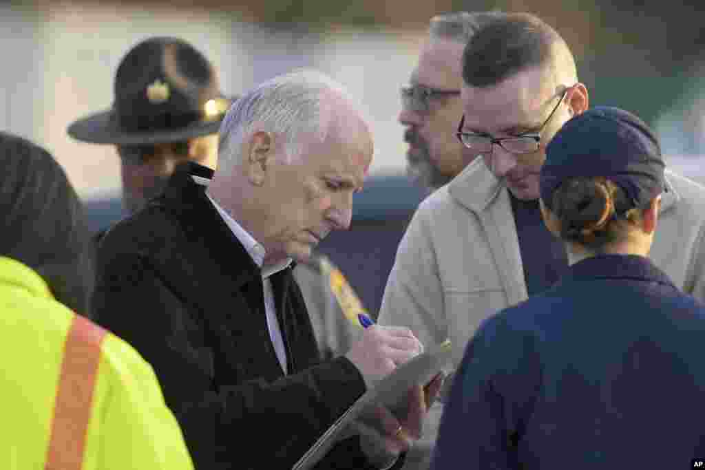 Paul J. Wiedefeld, center, Maryland's transportation secretary, works near the scene where a container ship collided with a support on the Francis Scott Key Bridge, March 26, 2024, in Baltimore. 