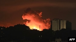 Fire and smoke rise above buildings in Gaza City during an Israeli airstrike, on Oct. 13, 2023.