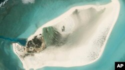 FILE - This satellite photo from Planet Labs PBC shows Triton Island in the South China Sea on Feb. 20, 2023. (Planet Labs PBC via AP)