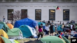 A student protester flies a kite inside the protest encampment on the Columbia University campus, April 29, 2024, in New York. Columbia University on Monday began suspending pro-Palestinian activists who refused to dismantle a tent encampment on its New York City campus