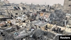 People search through the rubble of damaged buildings following an Israeli air strike on Palestinian houses, in Rafah, southern Gaza Strip, Dec. 12, 2023. 