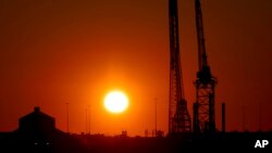 Cranes stand by at Tradepoint Atlantic terminal near the wreckage of the Francis Scott Key Bridge in Baltimore, Maryland, March 30, 2024, in Baltimore.