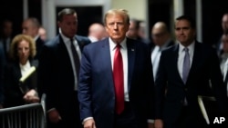 FILE - Former President Donald Trump leaves Manhattan criminal court, Feb. 15, 2024, in New York. A New York judge on March 15, 2024, delayed Trump's hush-money criminal trial to give the former president's attorneys time to review new evidence.