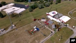 FILE - A drone view shows the site of a rally for Republican presidential candidate former President Donald Trump, in Butler, Pennsylvania, July 15, 2024. Trump was lightly wounded by a bullet at the July 13 rally; the shooter reportedly was atop one of the buildings at left.