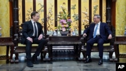 In this photo released by Xinhua News Agency, visiting Tesla founder and CEO Elon Musk, left, meets with Chinese Premier Li Qiang in Beijing, April 28, 2024. (Wang Ye/Xinhua via AP)