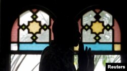 FILE - A man attends prayers at a mosque in Libreville, Gabon, Jan. 27, 2017. Muslims invited Christians to join in their prayers for peace on April 10, 2024, as the country holds meetings to discuss transferring power to a civilian government.