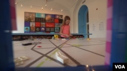 Young visitor playing with lego bricks at "The Brick City" exhibition, National Building Museum, Washington, DC