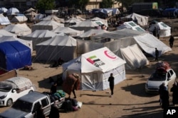 Palestinians displaced by the Israeli bombardment of the Gaza Strip set up tents in Deir al-Balah, Dec. 26, 2023.