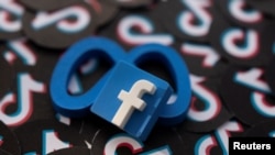 FILE - Facebook, Meta and TikTok logos are seen in this illustration taken Feb. 15, 2022. 