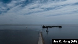 Farmland in the Tulare Lake Basin is submerged in water in Corcoran, Calif., Thursday, April 20, 2023, after more than a dozen atmospheric rivers dumped record-setting rain and snowfall.
