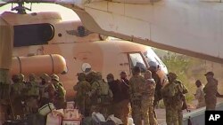 This undated photograph handed out by French military shows Russian mercenaries boarding a helicopter in northern Mali. French Army via AP, File
