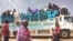 People board a truck as they leave Khartoum, Sudan, June 19, 2023. 