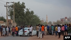 People gather on the street in east Khartoum on Apr. 16, 2023, as fighting in Sudan raged for a second day in battles between rival generals. 