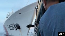 This videograb taken and released on Oct. 22, 2023 shows a collision between a Chinese Coast Guard ship (L) and Philippines' resupply boat (R) during a resupply mission near the Second Thomas Shoal. (AFP/Armed Forces of the Philippines)