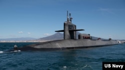 FILE - The guided missile submarine USS Florida conducts a brief stop in the Bay of Naples, Naples, Italy, March 16, 2023. 