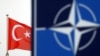 FILE: Bendera Turki berkibar di sebelah logo NATO di markas besar Aliansi di Brussels, Belgia, 26 November 2019. (REUTERS/Francois Lenoir)