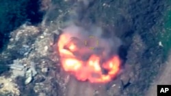 An explosion is seen over an area where, according to Azerbaijan, there were positions of Armenian armed forces in the separatist territory of Nagorno-Karabakh, in Azerbaijan on Sept. 19, 2023. (Azerbaijan Ministry of Defense via AP)