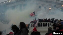 FILE - More than 500 have pleaded guilty to federal charges, while dozens have been convicted at trial in connection to the Jan. 6, 2021, assault on the U.S. Capitol in Washington. The FBI says it is seeking information about more than 260 others suspected of committing violence.