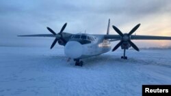 A Polar Airlines' Antonov-24 passenger aircraft following its landing on the Kolyma river in the Yakutia region, Russia, Dec. 28, 2023. (Russia's Eastern Siberian Transport Prosecutor's Office/Handout via Reuters) 