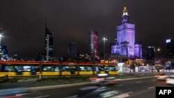 This photograph taken on March 23, 2024, shows the Palace of Culture in Warsaw illuminated after being switched off to mark the Earth Hour environmental campaign to bring awareness on environmental issues. 