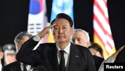FILE - South Korean President Yoon Suk Yeol salutes at Seoul Air Base in Seongnam, South Korea, July 26, 2023.