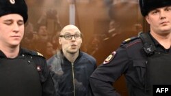 Russian poet Artyom Kamardin stands inside the defendants' glass cage during his verdict announcement at a court in Moscow on Dec. 28, 2023. He received a seven-year sentence for reciting versus against Russia's war in Ukraine. 