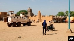 FILE - U.N. forces patrol the streets of Timbuktu, Mali, on Sept. 26, 2021. The United Nations is in the midst of a six-month exit from Mali on orders of the West African nation’s military junta. Residents of northern Mali now say they are effectively stuck in a war zone.