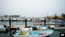 A fisherman removes water from his boat before the arrival of Hurricane Norma, in Cabo San Lucas, Mexico, Oct. 20, 2023. Norma is heading for Mexico's Baja California Peninsula, while Hurricane Tammy grows in the Atlantic.