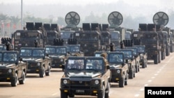FILE - Military personnel participates in a parade on Armed Forces Day in Naypyitaw, Myanmar, March 27, 2021. 