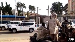 A grab taken from an AFPTV video shows a convoy leaving Khartoum towards Port Sudan, on Apr. 23, 2023, as people flee the battle-torn Sudanese capital.