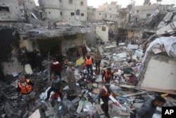 Palestinians look for survivors of the Israeli bombardment of the Gaza Strip in Rafah, Dec. 12, 2023.