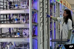 An engineer works in the research and development area at the Ohmium manufacturing facility in Chikkaballapur, outside Bengaluru, India, Tuesday, April 25, 2023. (AP Photo/Aijaz Rahi)