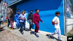 A migrant family from Venezuela arrives at a church-run shelter in El Paso, Texas, May 12, 2023. The U.S.-Mexico border was relatively calm Friday; chaos had been feared following a rush by migrants to enter the U.S. before pandemic-related immigration restrictions ended.