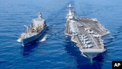 The USS Gerald R. Ford aircraft carrier refuels from the underway replenishment oiler USNS Laramie in the eastern Mediterranean Sea, Oct. 11, 2023. (U.S. Navy photo via AP)