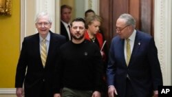 Ukrainian President Volodymyr Zelenskyy walks with Senate Majority Leader Chuck Schumer of NY, and Senate Minority Leader Mitch McConnell of Ky., during a visit to Capitol Hill in Washington, Dec. 12, 2023.