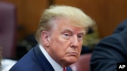 Former President Donald Trump sits at the defense table in a Manhattan court, Tuesday, April 4, 2023, in New York. Trump is appearing in court on charges related to falsifying business records in a hush money investigation. (AP Photo/Seth Wenig, Pool)