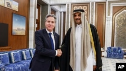 U.S. Secretary of State Antony Blinken, left, meets with Qatar's Emir Sheikh Tamim Bin Hamad Al Thani at Lusail Palace in Lusail, Jan. 7, 2024. 