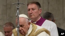 Pope Francis presides over an Easter vigil ceremony in St. Peter's Basilica at the Vatican, April 8, 2023. 
