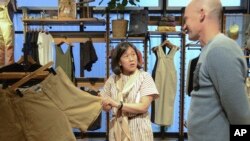 U.S. Trade Representative Katherine Tai, center, visits an outlet of outdoor equipment and clothing retailer Patagonia in Tokyo, April 19, 2023.